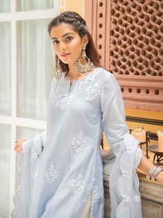 Set of 3 consists of kurta, palazzo and dupatta. Noor, bringing the magic of festivities straight to your closet in shades of pastels. Delicately adorned with kasida mirror and thread detailing. Kurta: A elegant powder blue chanderi kurti with kasida mirror and thread work on the neckline, sleeves & hemline. Dupatta: An elegant scalloped dupatta, complete with handwork gota magzi back detailing finished with mirror work. Pants: Straight fit cotton pant. Occassion: Day Wear, Evening Wear, Fes Pakistani Party Wear, Timeless Outfits, Kurta Designs Women, Basic Wear, Lawn Shirts, Lawn Suits, Designs For Dresses, Suit Designs, Trendy Decor