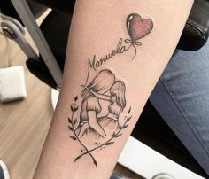 a woman's arm with a tattoo on it and a heart shaped balloon in the background