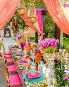 a long table covered in lots of pink and orange flowers