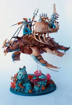 a statue of a dragon riding on the back of a boat