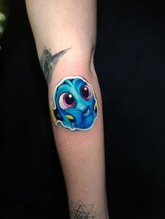 a person with a tattoo on their arm has a blue stitcher in the shape of an eye