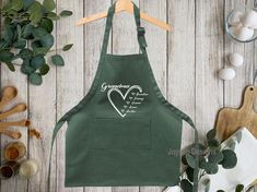 an apron with the words grandma on it next to other kitchen utensils and ingredients