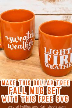 two orange coffee mugs sitting on top of a wooden table next to each other