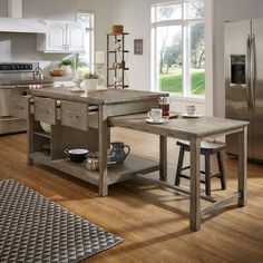 a kitchen island with two stools in front of it and an open shelf on the other side