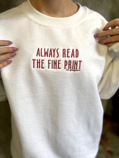 a woman wearing a white shirt that says, always read the fine print