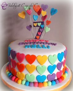 a birthday cake decorated with hearts and the number seven