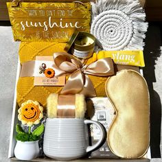 an open box containing items for a woman's spa and body care products, including sunflowers