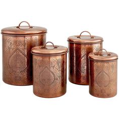 three copper canisters with ornate designs on them