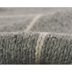 an image of a close up view of some yarn on a bed sheet or blanket