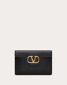 Valentino Garavani Locò large clutch bag in calfskin leather with metallic VLogo Signature detail. - Antique brass finish logo and hardware - Nappa leather lining. Interior: open slip pocket and three card slots - Dimensions: W28xH19xD1 cm / W11xH7.4xD0.3 in. - Made in Italy Clutch Outfit, Valentino Wallet, Valentino Clutch, Bow Mules, Escape Bag, Studded Sneakers, Oxford Boots, Large Clutch, Boot Accessories