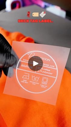 a person in an orange jacket holding up a piece of paper with the words caution on it