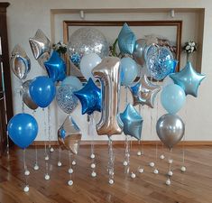 blue and silver balloons are arranged on the floor