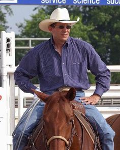 a man in a cowboy hat is riding a horse