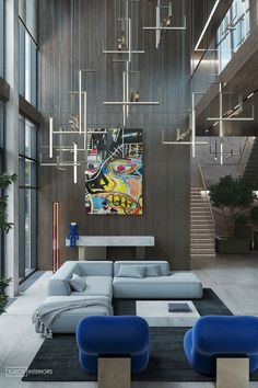 a modern living room with blue couches and art on the wall