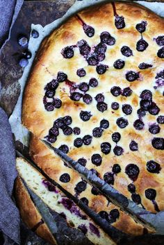 a blueberry pie is cut into slices and ready to be eaten