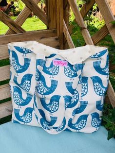 a blue and white bag sitting on top of a wooden bench