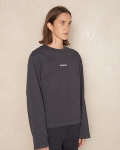 Logo longsleeve T-shirt by Acne Studios in black. Relaxed fit crewneck tee crafted from midweight cotton jersey. A wardrobe essential featuring the iconic logo stamped on the center front, adding a touch of contemporary chic. 100% Cotton.Made in Portugal. Branded Long Sleeve Tops For Streetwear, Long Sleeve Washed Black T-shirt For Fall, Long Sleeve Logo Print T-shirt For Loungewear, Black Organic Cotton Crew Neck Top, Long Sleeve Organic Cotton Tops For Streetwear, Long Sleeve Logo Print Loungewear T-shirt, Washed Black Crew Tops With Ribbed Cuffs, Washed Black Crew Top With Ribbed Cuffs, Washed Black Long Sleeve Top With Letter Print