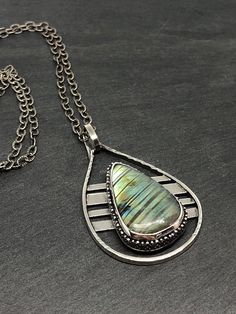 A beautiful striped labradorite set in a custom made sterling silver setting.   Total height of the pendant is 51mm (2 inches). Total width is 31mm (1.25 inches). You have the option to purchase the pendant only, or with a sterling silver chain, your choice of length between 16-24 inches. Silversmithing Jewelry, Metal Jewelry Making, Wire Jewelry Designs, Silver Jewelry Handmade, Sterling Silver Necklace Pendants, Silver Pendants, Silver Chain Necklace, Silver Pendant Necklace, Sterling Silver Chain