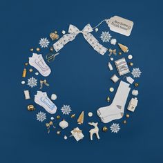 various items are arranged in the shape of a circle on a blue background with snowflakes