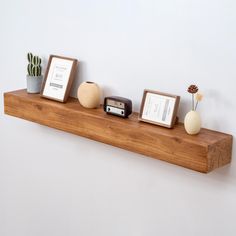 there is a shelf with three different items on it and two framed pictures next to each other