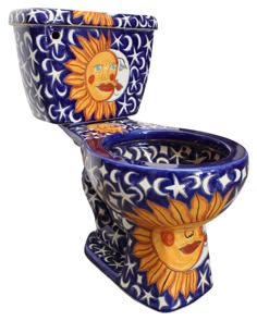 an artisticly painted toilet bowl with sun and moon designs on the lid, isolated against a white background