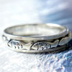 The fishes are very helpful in increasing the good luck of the house. This ring design is inspired by the swimming fishes. Spin the fish band, enjoy prosperity and good luck.  If you are looking for a unique and stylish gift for your friends and yourself who loves fish or fishing? Look no further than the Swimming Fish Spinner Ring, Christian Fish Ring, Men's Fish Ring, Fish Ring Design, Anxiety Ring Sterling Silver Fidget, Animal Ring! This sterling silver ring features a beautiful fish design Coastal Jewellery, Fish Ring, Swimming Fish, Animal Rings, Meditation Rings, Dope Jewelry, Funky Jewelry, Spinner Ring, Spinner Rings