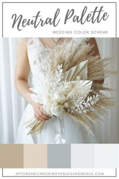 a woman in a wedding dress holding a bouquet with white flowers and feathers on it