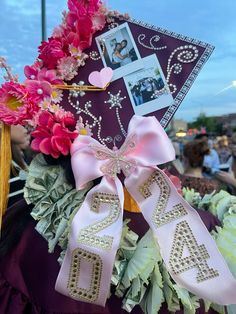 a graduation cap decorated with flowers and ribbons