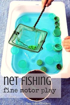 a child's hand holding a fishing net in a bathtub filled with water