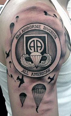 a man with a tattoo on his arm that says airborne division, all american and parachutes