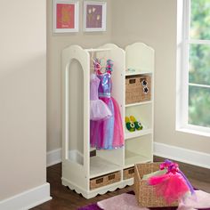 a child's closet with baskets and clothes