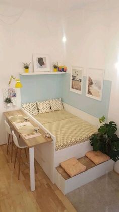 a bed sitting on top of a wooden floor next to a desk