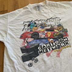 a white t - shirt with cartoon network on the front and an image of cars