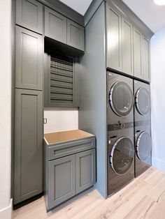 a washer and dryer are in the corner of this laundry room that is built into the wall