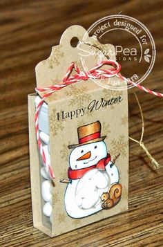 a small gift bag with a snowman on it and a tag attached to it