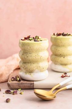 two cups filled with pudding sitting on top of a table