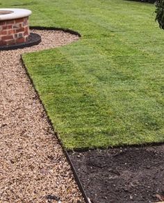 a garden with gravel and grass in the middle