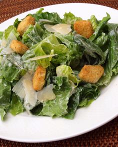 lettuce salad with croutons and parmesan cheese on the side