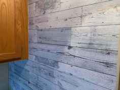 a bathroom with wood paneling on the wall