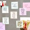 a bulletin board with pictures and writing on the back of it that is covered in post - it notes