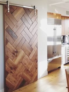 a kitchen with wood flooring and stainless steel appliances