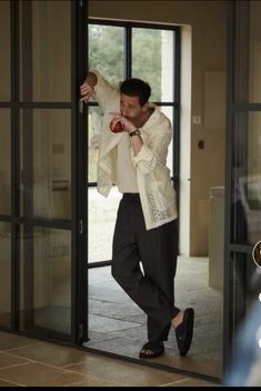 a man standing in front of a glass door