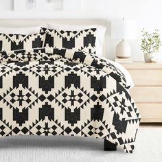 a bed with black and white patterns on it