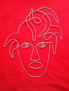 a red t - shirt with an image of a man's face on it