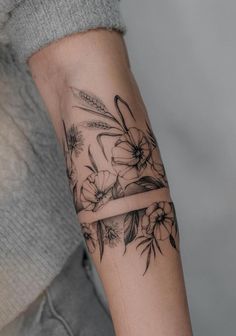 a woman's arm with flowers on it