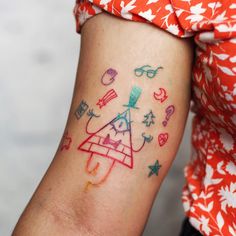 a woman's arm with colorful tattoos on it