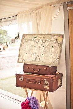 two suitcases stacked on top of each other in front of a window with the words mademoiselle wedding decor