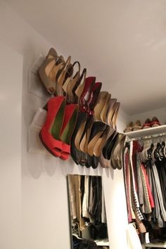 an image of shoes hanging on the wall using crown molding to store them for sale