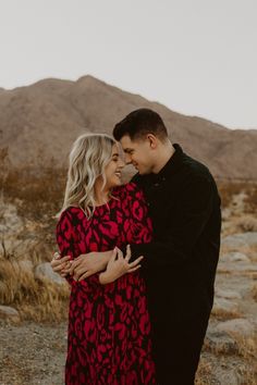 a man and woman hugging in the desert