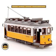 a yellow and white trolley car with the words montesso on it's side